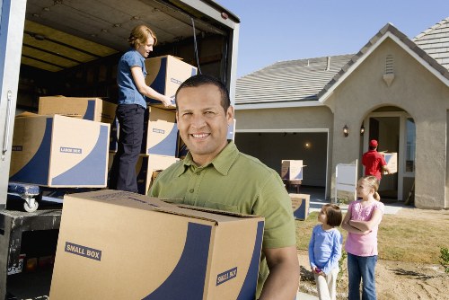 Packed moving boxes and furniture ready for transport